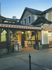 Restaurant exterior featuring tasteful signage and outdoor seating area.