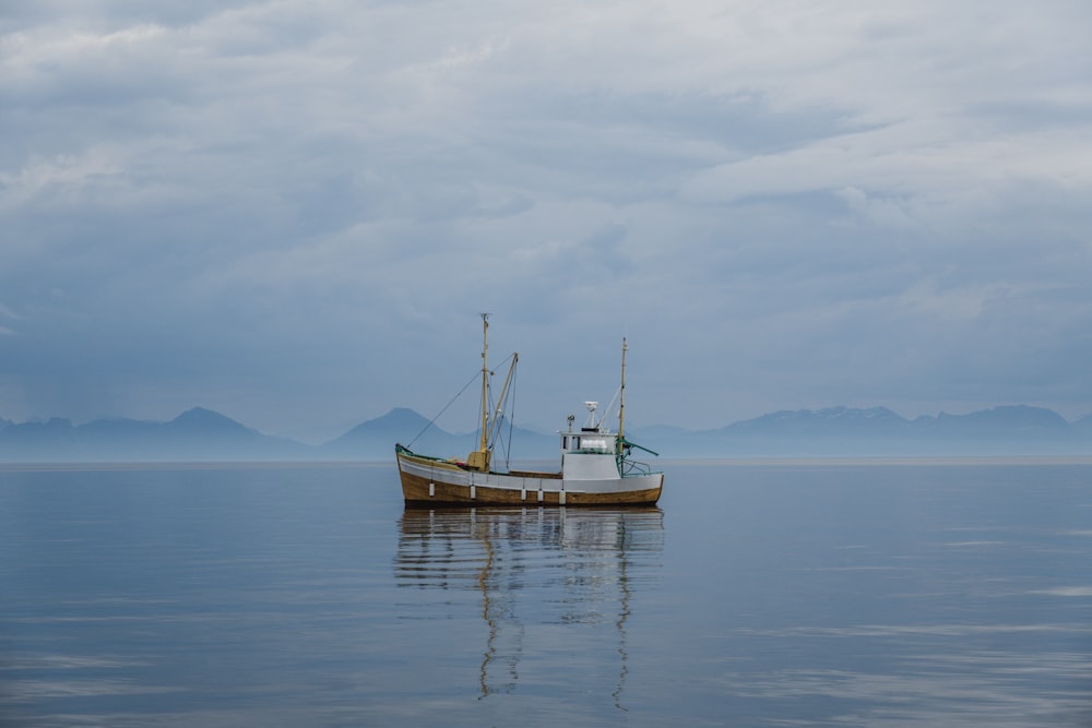 a boat floating on top of a large body of water