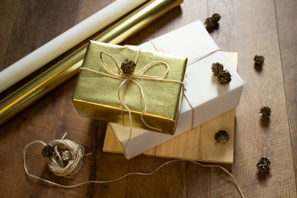 a wrapped present sitting on top of a wooden table
