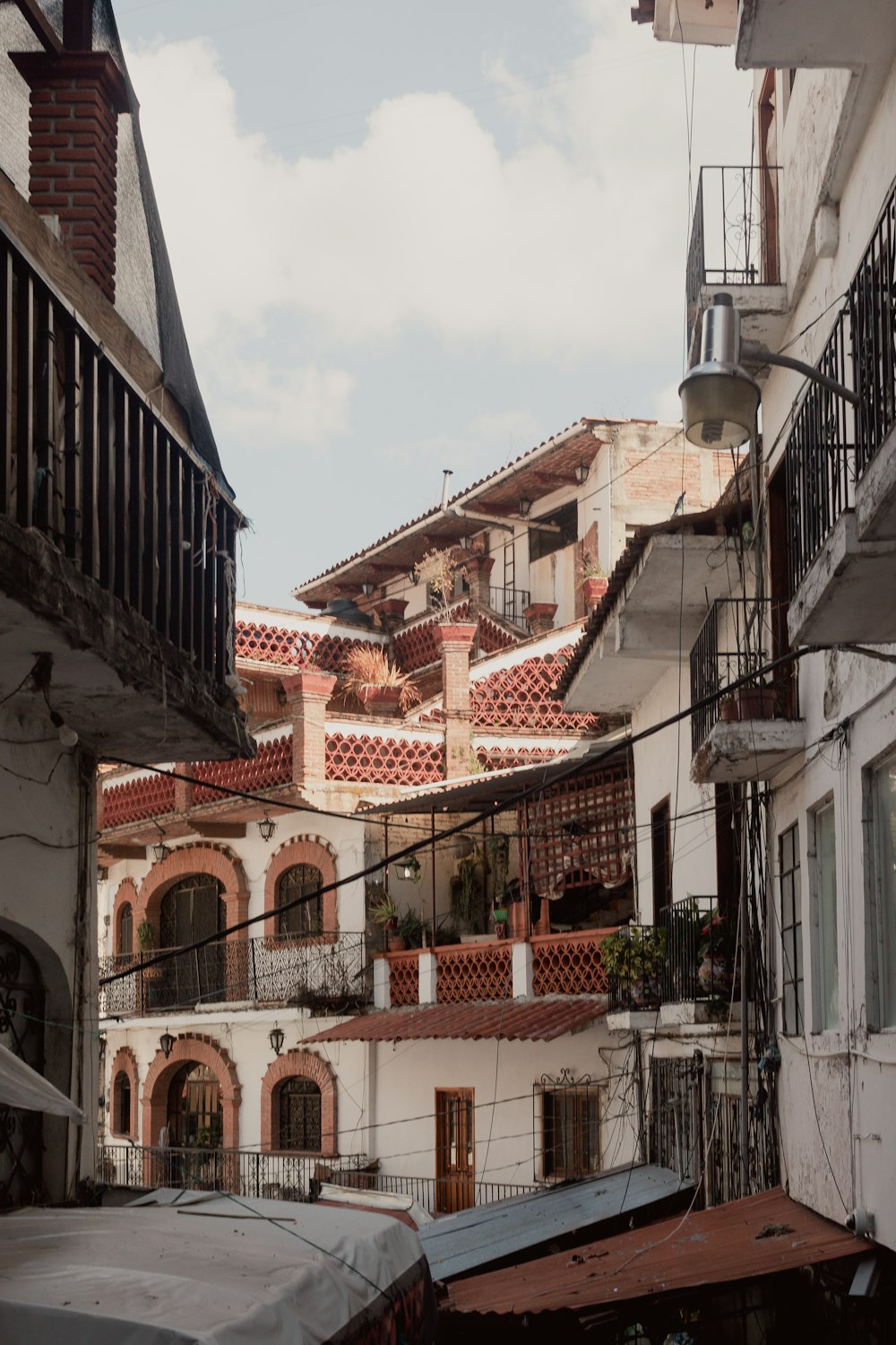 a view of a city street with buildings and balconies