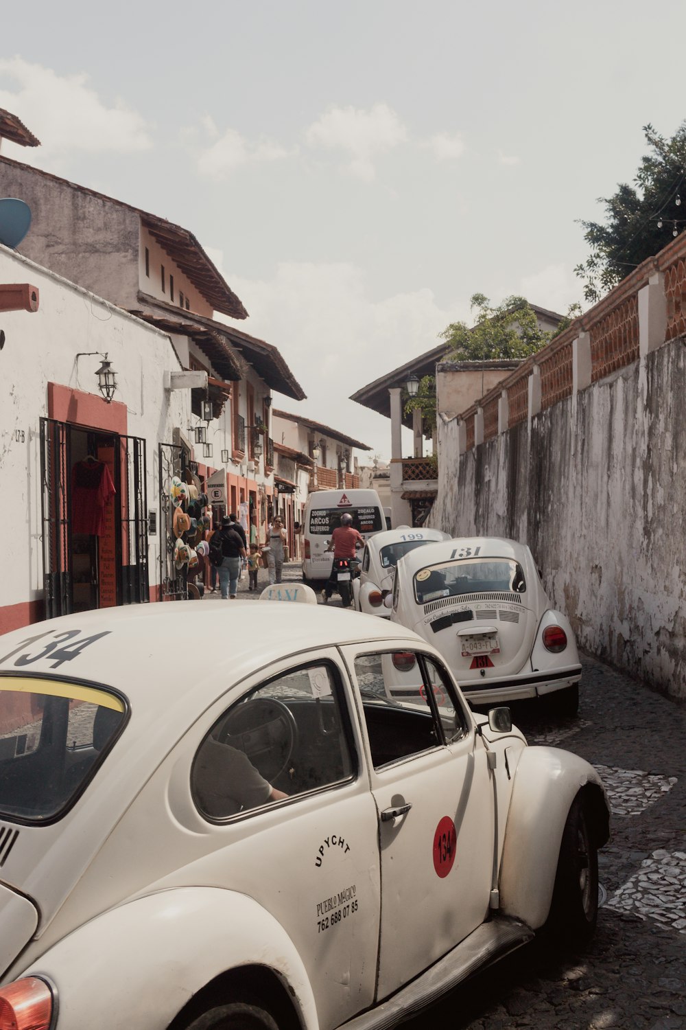 a white car parked on the side of a road