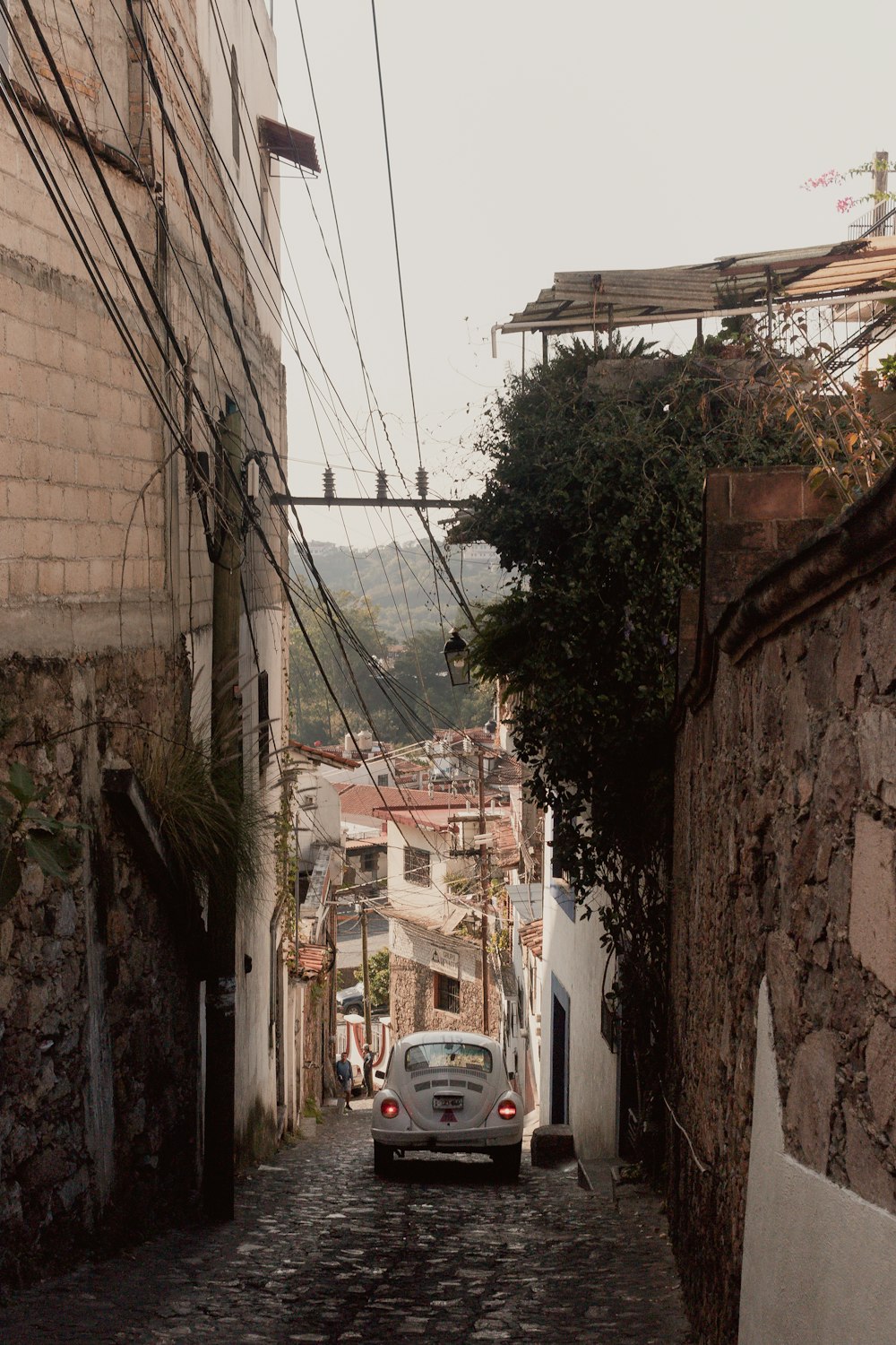 a car is parked on a cobblestone street