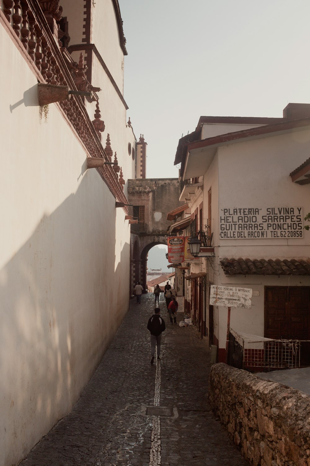 a person riding a bike down a cobblestone street