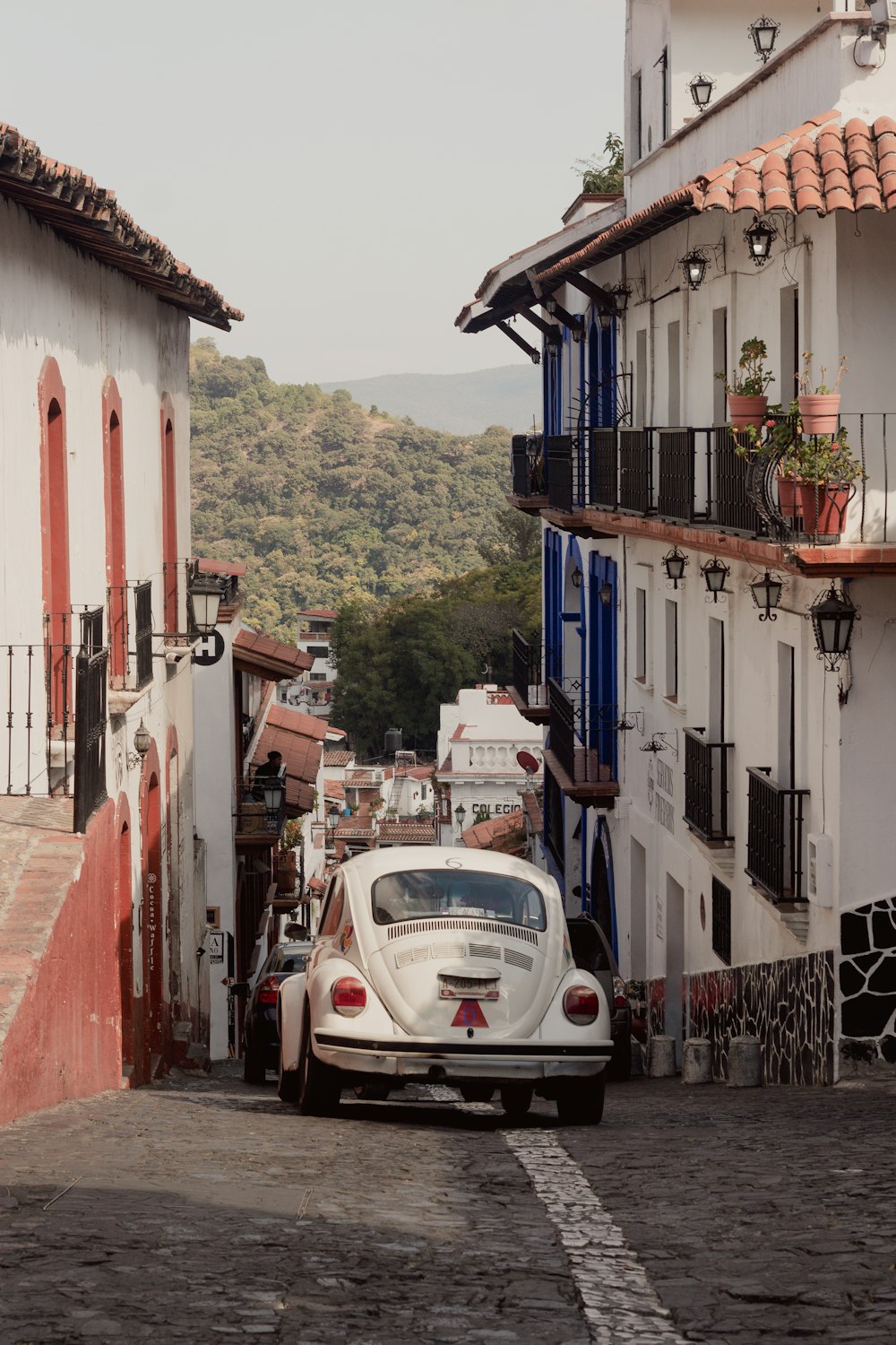 a white car parked in front of a building