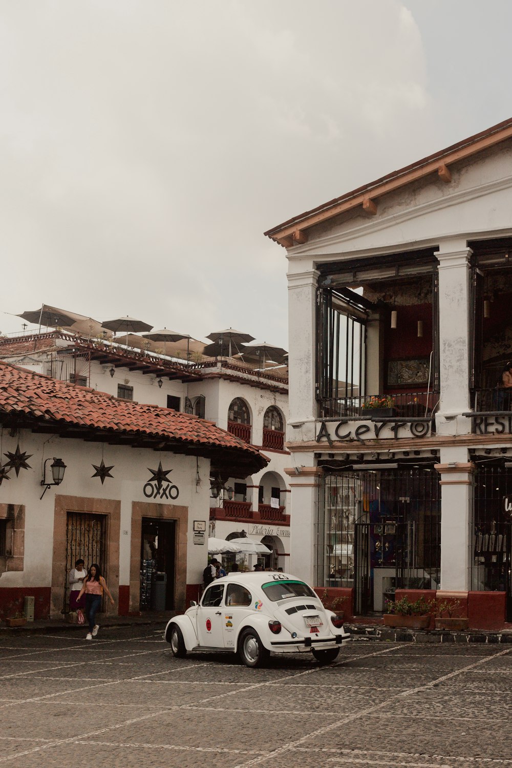 a white car parked in front of a building