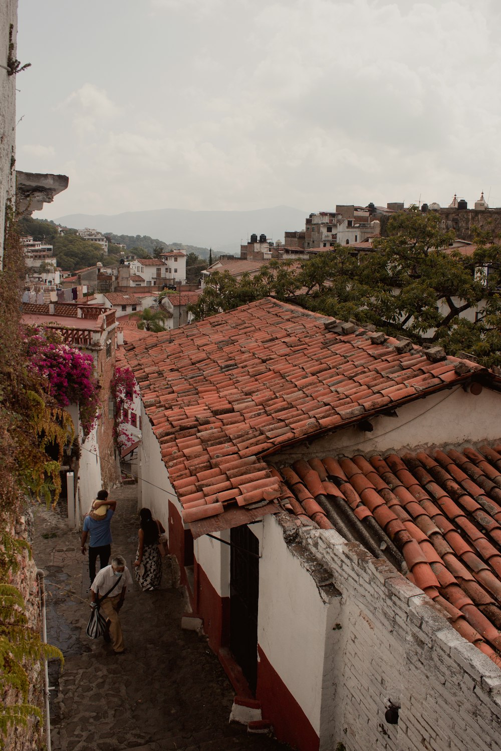 a man riding a bike down a cobblestone street