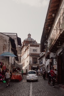 A Riviera VTC car navigating smoothly through a lively street market in the Riviera region.