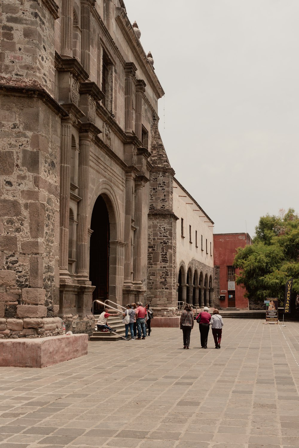 a group of people walking in front of a building