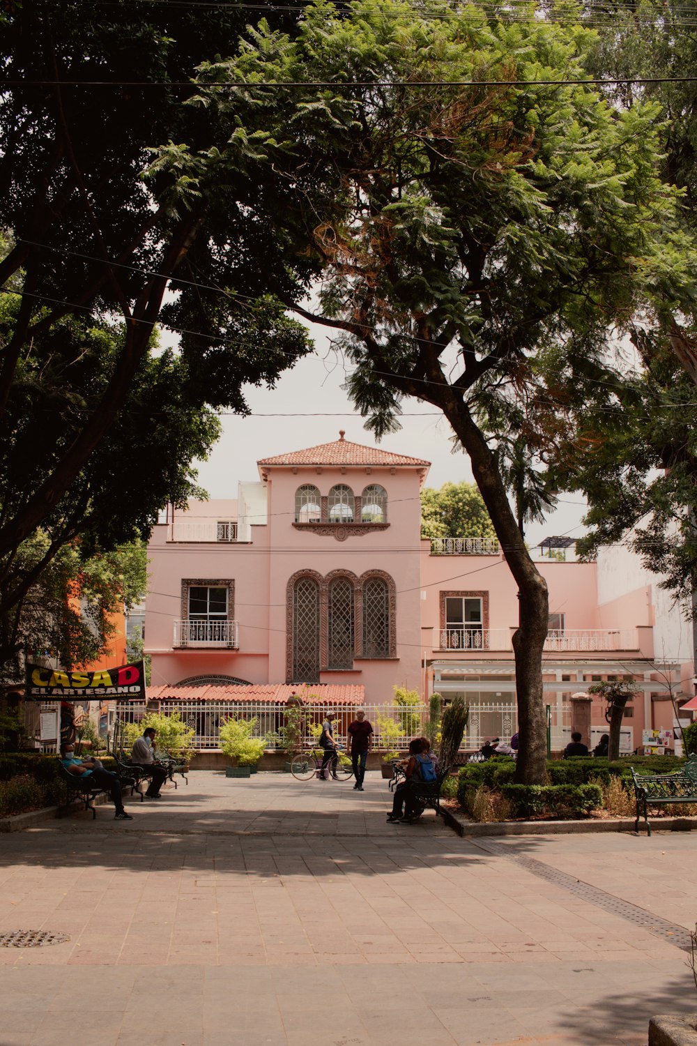 a large pink building with a clock on the front of it