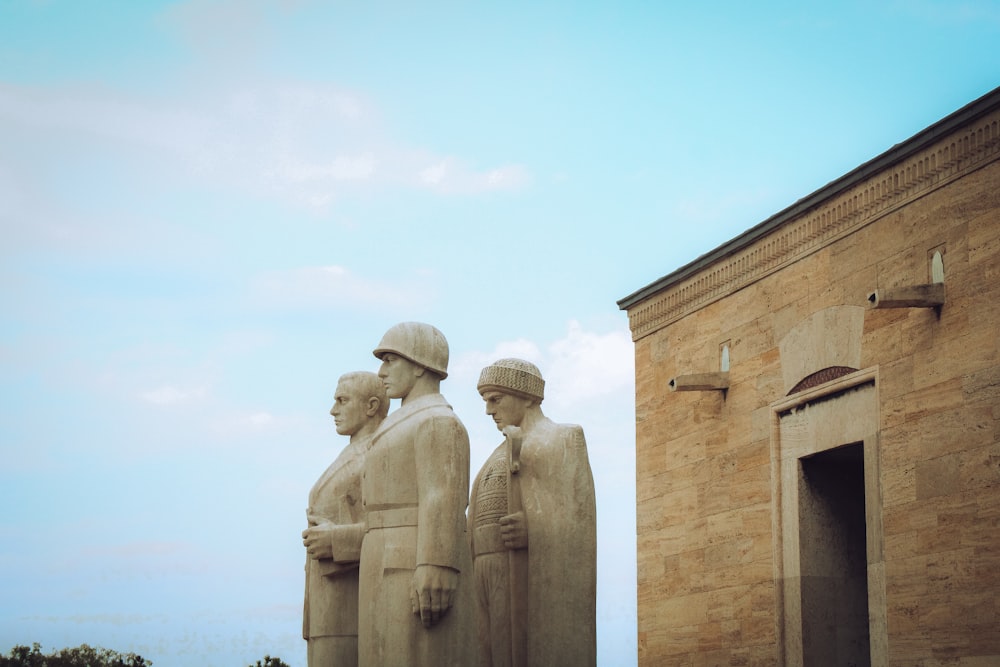 a group of statues of men standing next to each other