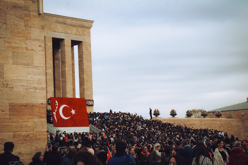 a large crowd of people standing in front of a building