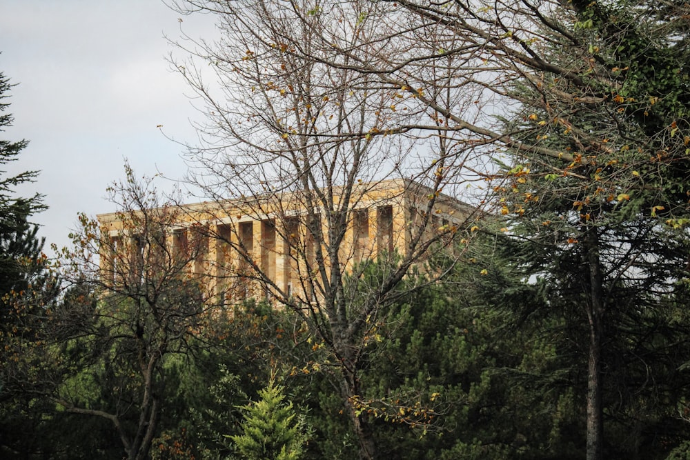 a tall building surrounded by trees on a cloudy day