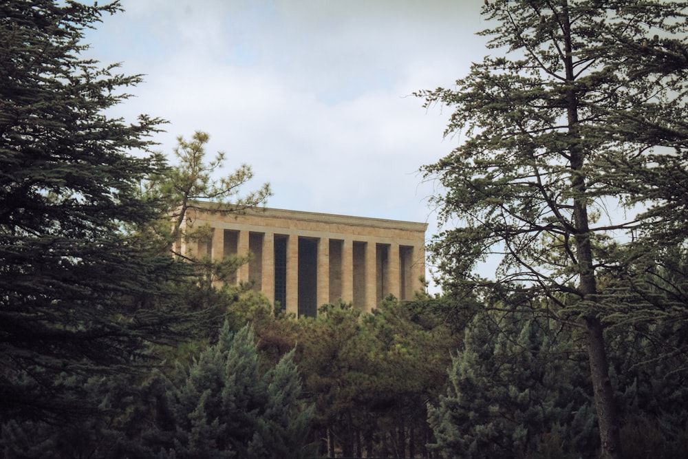 a tall building surrounded by trees on a cloudy day