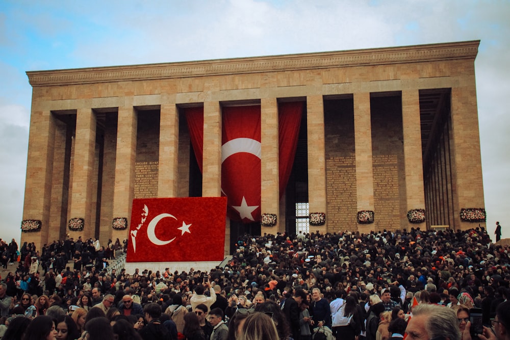 a large crowd of people standing in front of a building