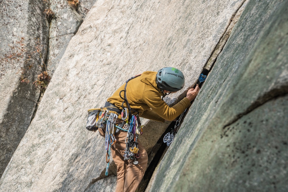 a man climbing up the side of a mountain