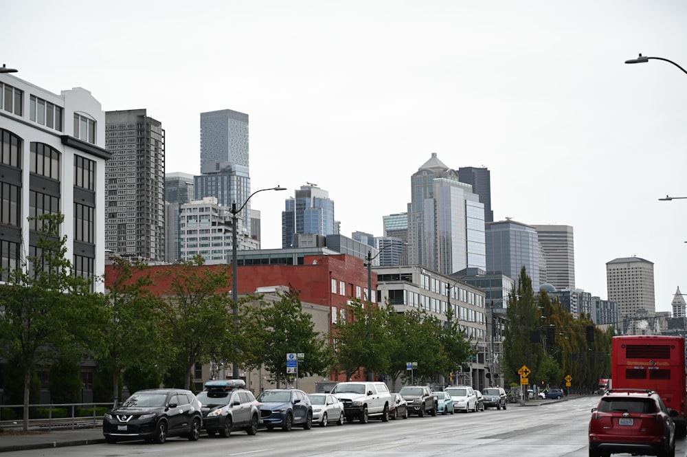 a city street filled with lots of traffic next to tall buildings