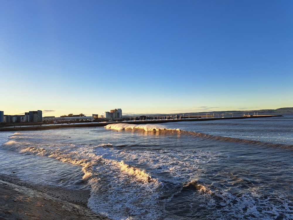 a body of water with a city in the background