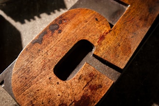 Close-up of a custom wooden sign with intricate carvings and personalized lettering.