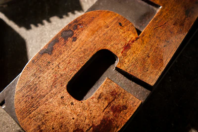Close-up of a finely crafted wooden sign with intricate lettering.