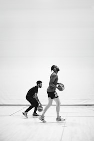 A basketball court with players dribbling and shooting.
