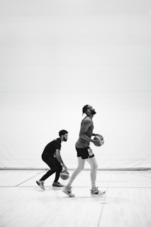 A basketball court with players dribbling and shooting.