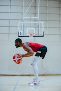 A basketball player practicing on the court.