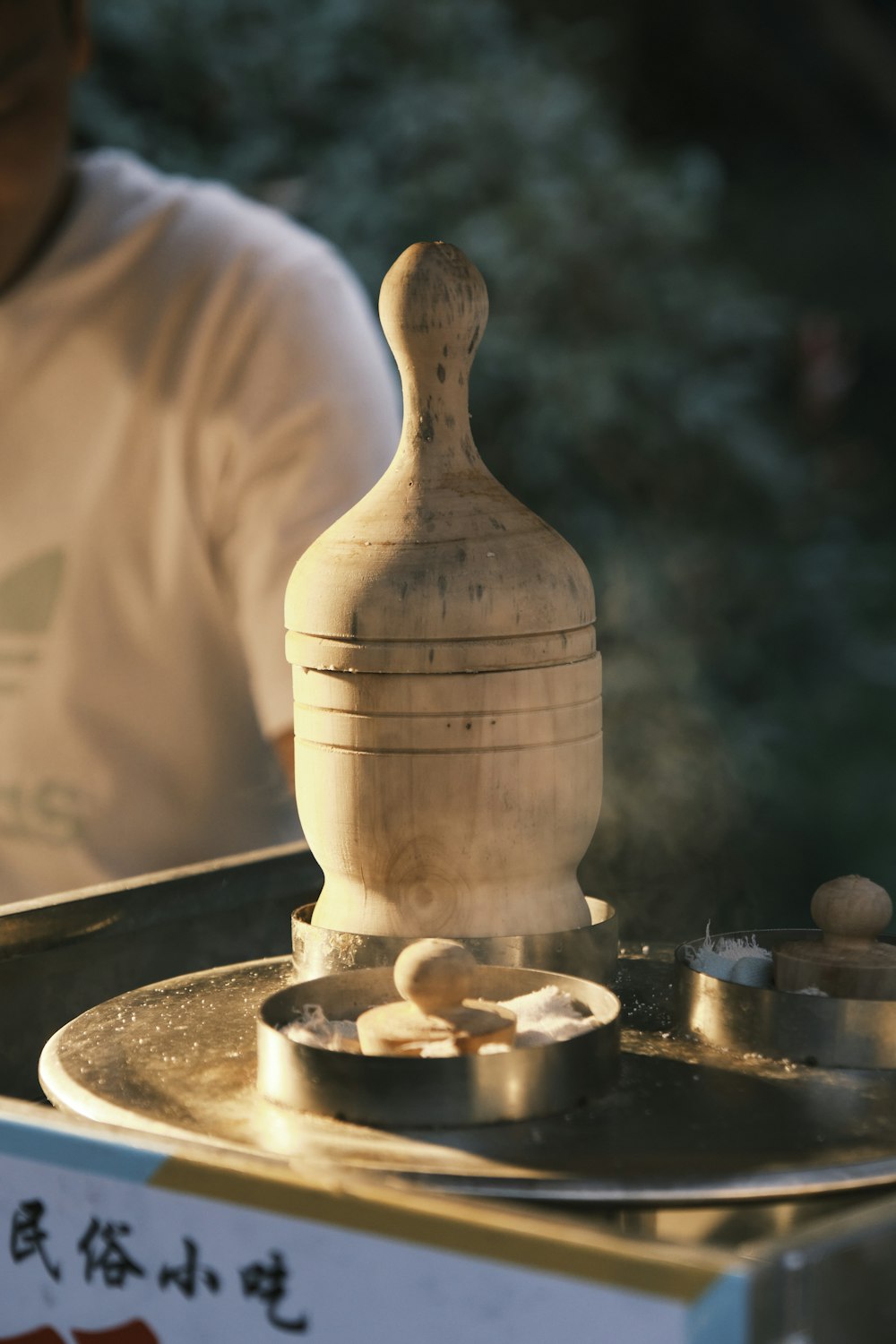 a man is making a vase out of wood