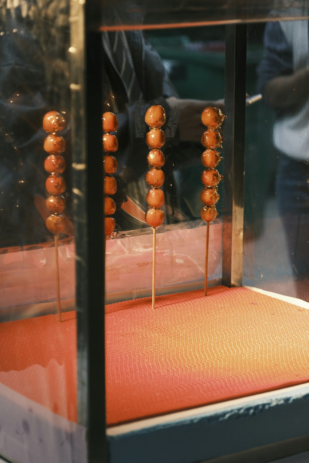 a bunch of food is being cooked on a stick