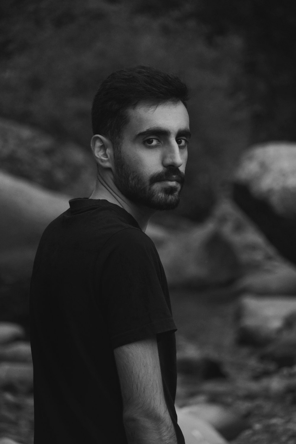 a black and white photo of a man with a beard