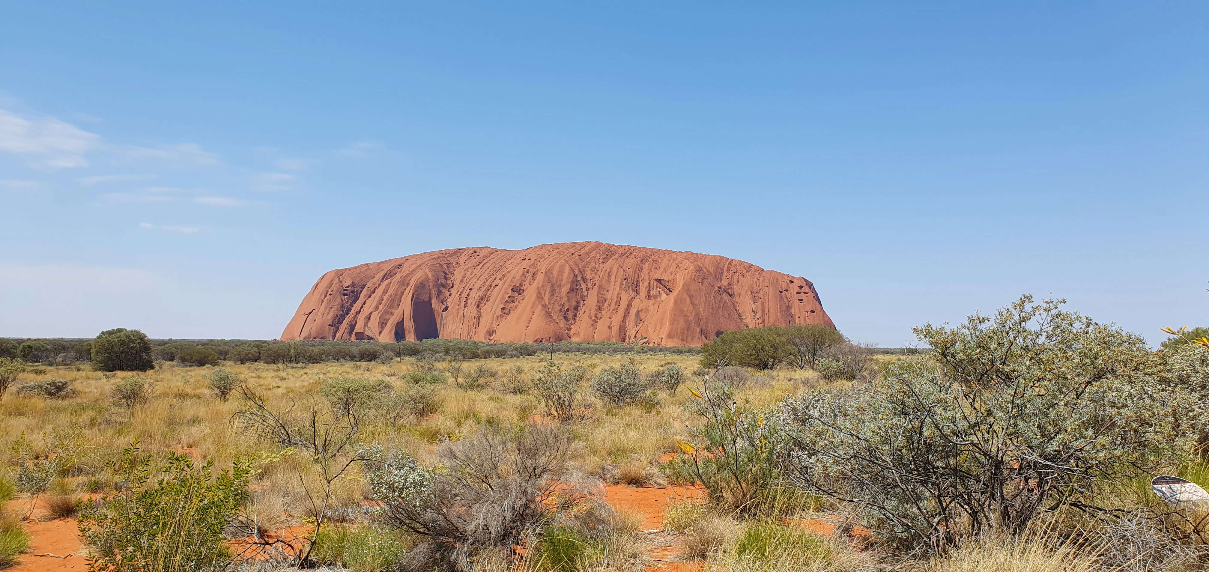 Red Centre desert landscape with dramatic rock formations under a vivid sunset sky