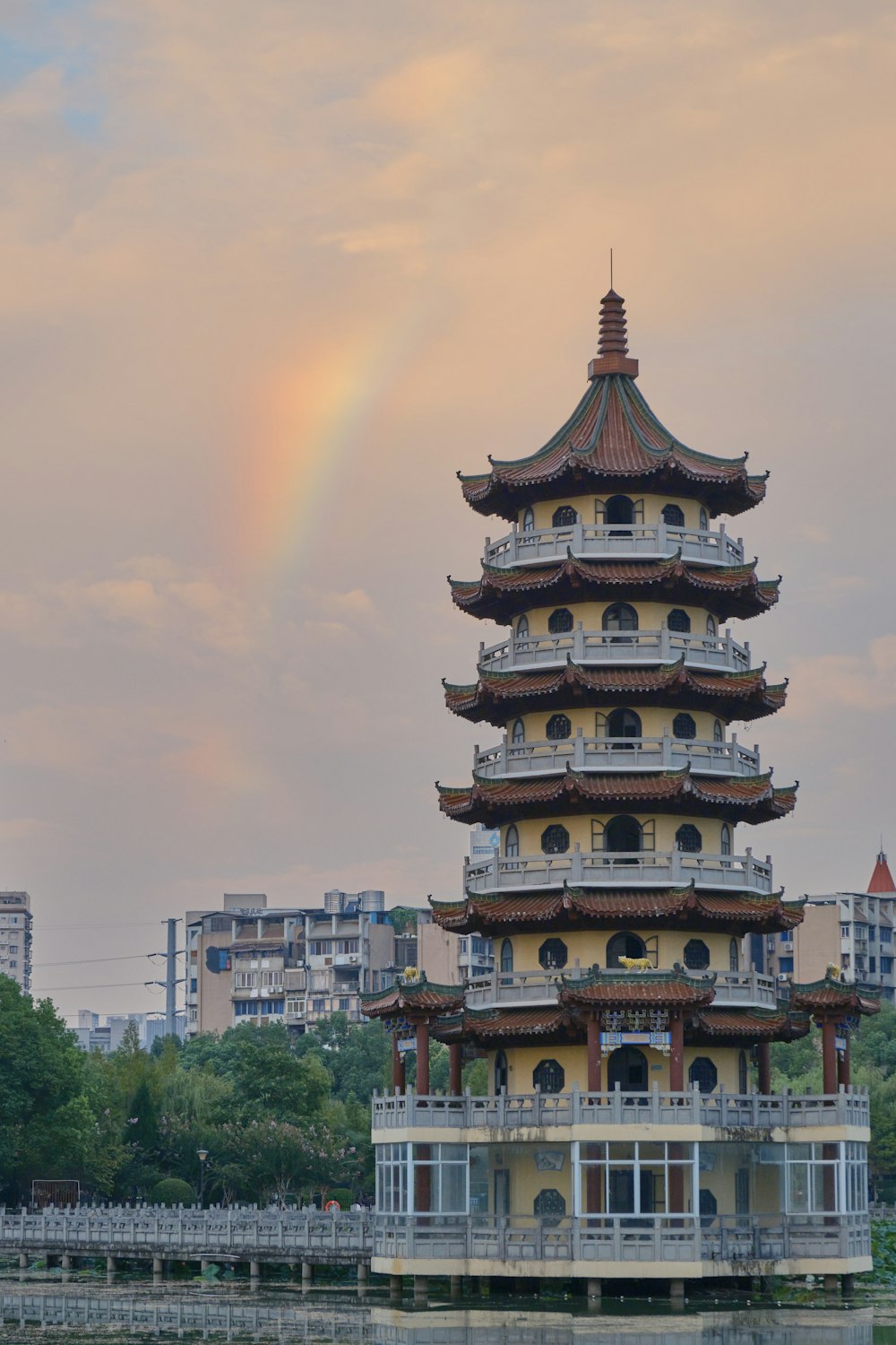 a tall building with a rainbow in the background