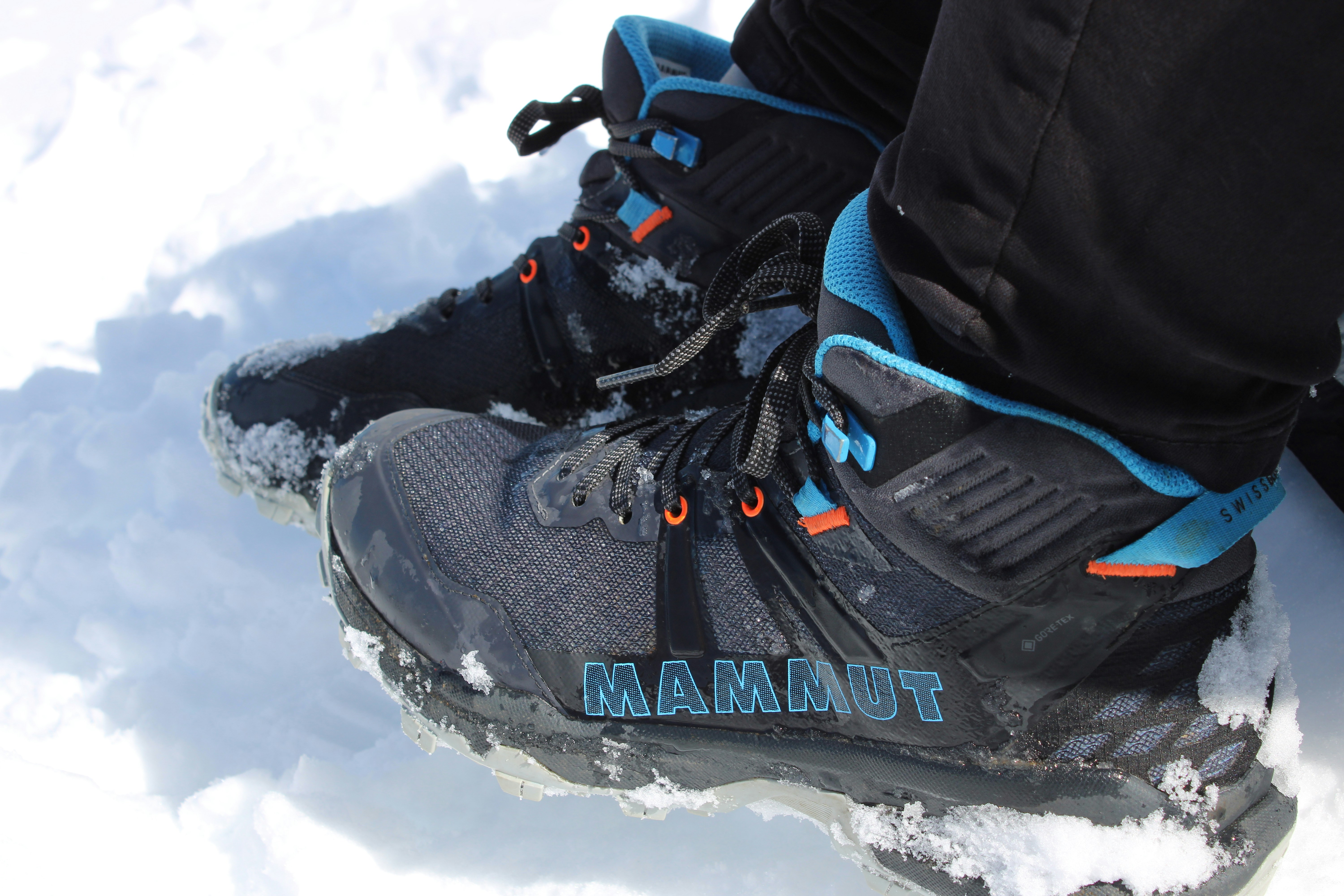 a close up of a person's shoes in the snow