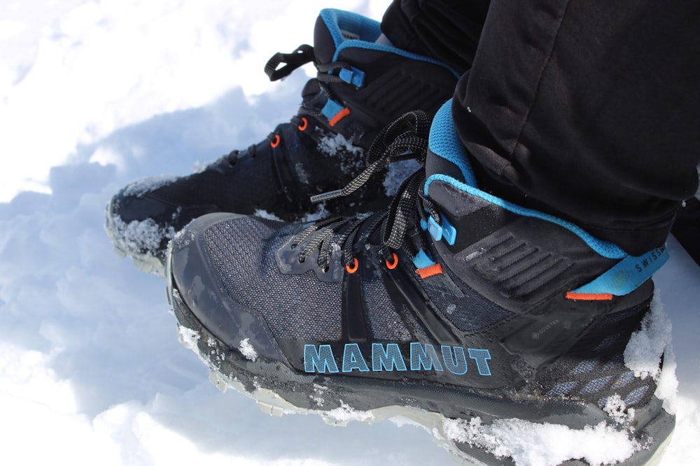 a close up of a person's shoes in the snow