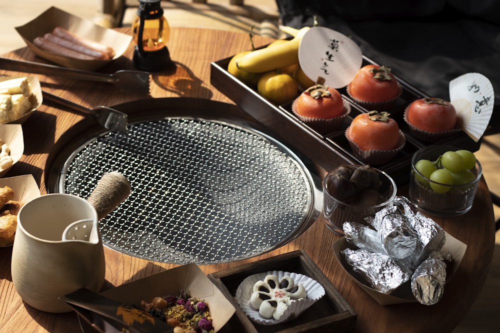 a wooden table topped with trays of food