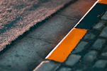 Close-up of a freshly painted curb with bright, clean lines on a sunny day.