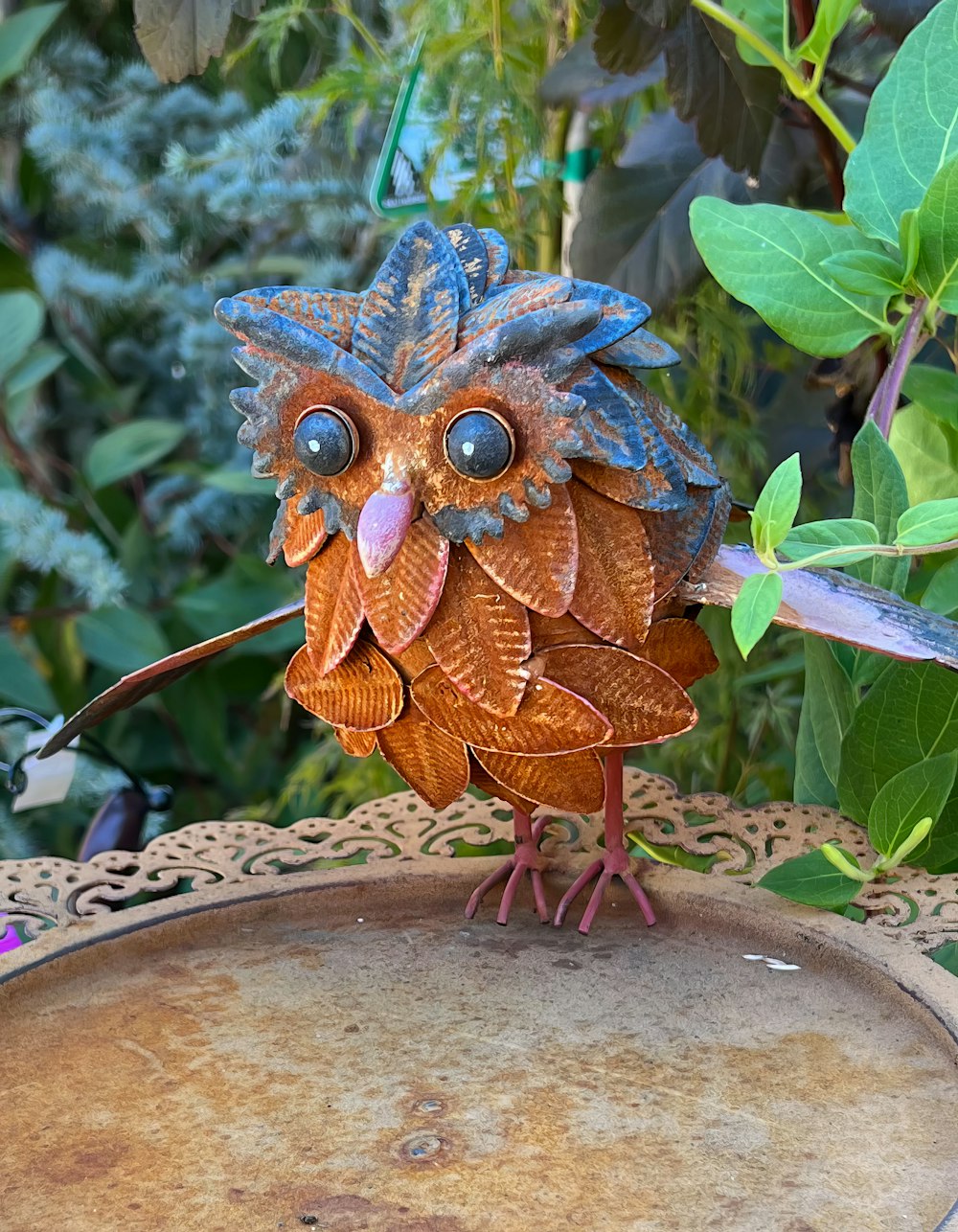 a bird made out of wood sitting on top of a table