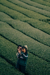 A farmer and a buyer shaking hands in a lush green field, symbolizing trust and partnership.