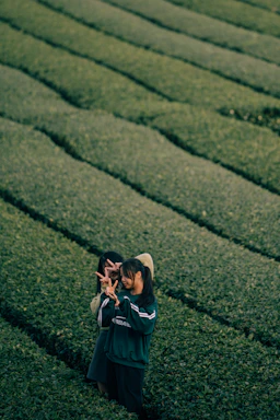 A friendly handshake between two farmers in a lush green field symbolizing partnership.