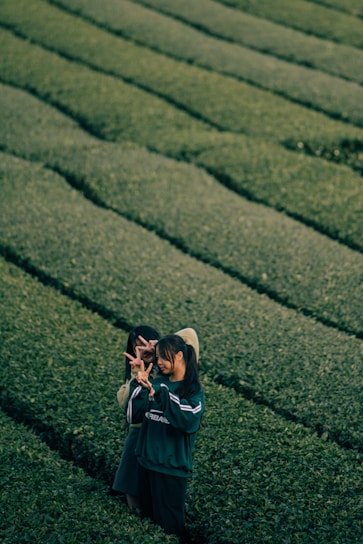 A farmer and a buyer shaking hands in a lush green field, symbolizing trust and partnership.