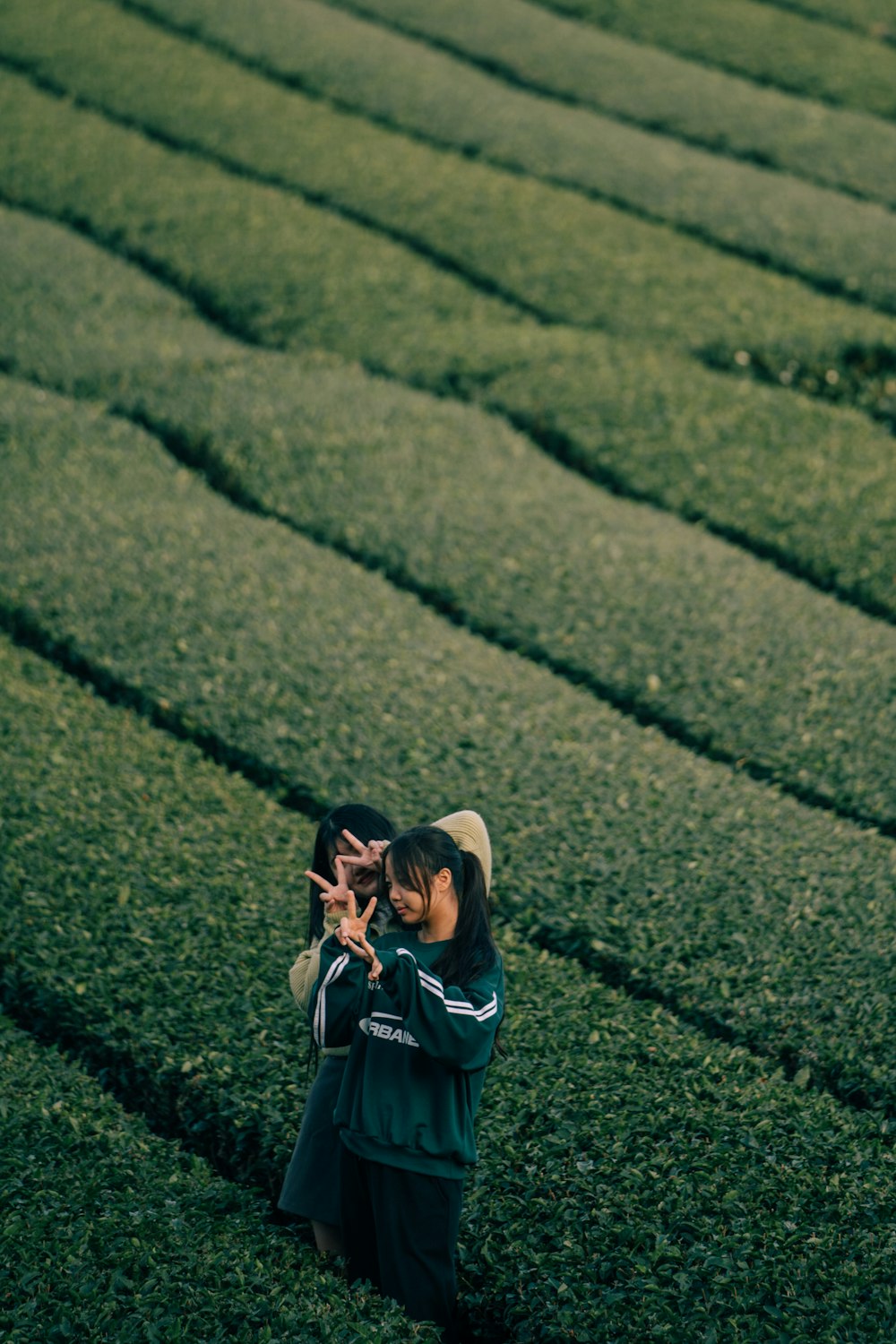 a woman taking a picture of a woman in a field