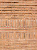 Wide shot of a restored brick wall showcasing clean, precise mortar lines.