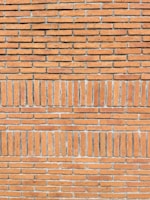 Close-up of detailed masonry work on a brick wall with clean lines