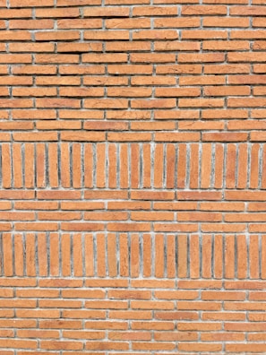 Wide shot of a restored brick wall showcasing clean, precise mortar lines.