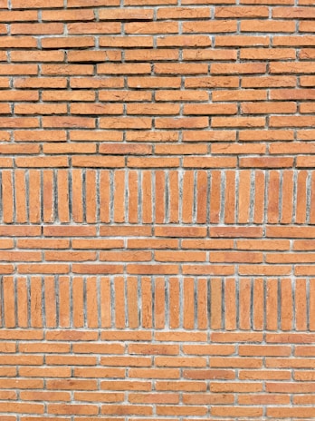 Close-up of a freshly laid brick wall showcasing precise mortar joints.