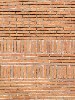 Close-up of detailed masonry work on a brick wall with clean lines