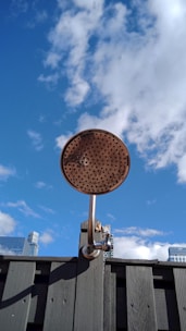 A clean, modern portable shower unit set up outdoors on a sunny day.