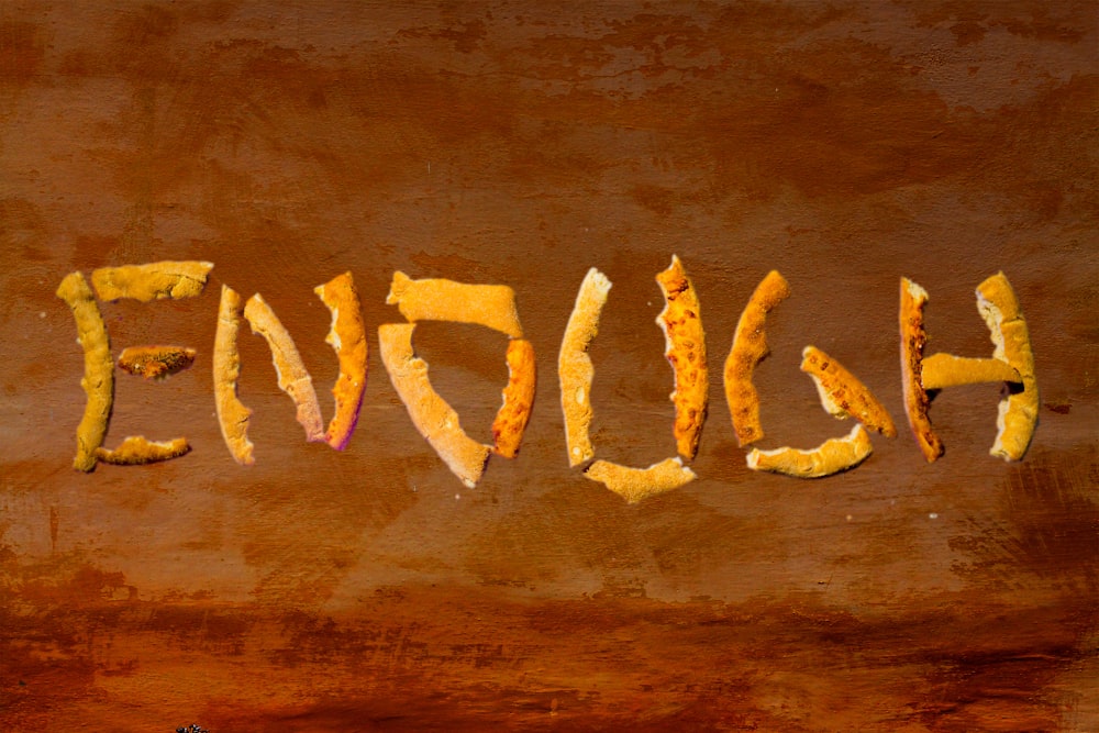 the word english written in orange peels on a brown background