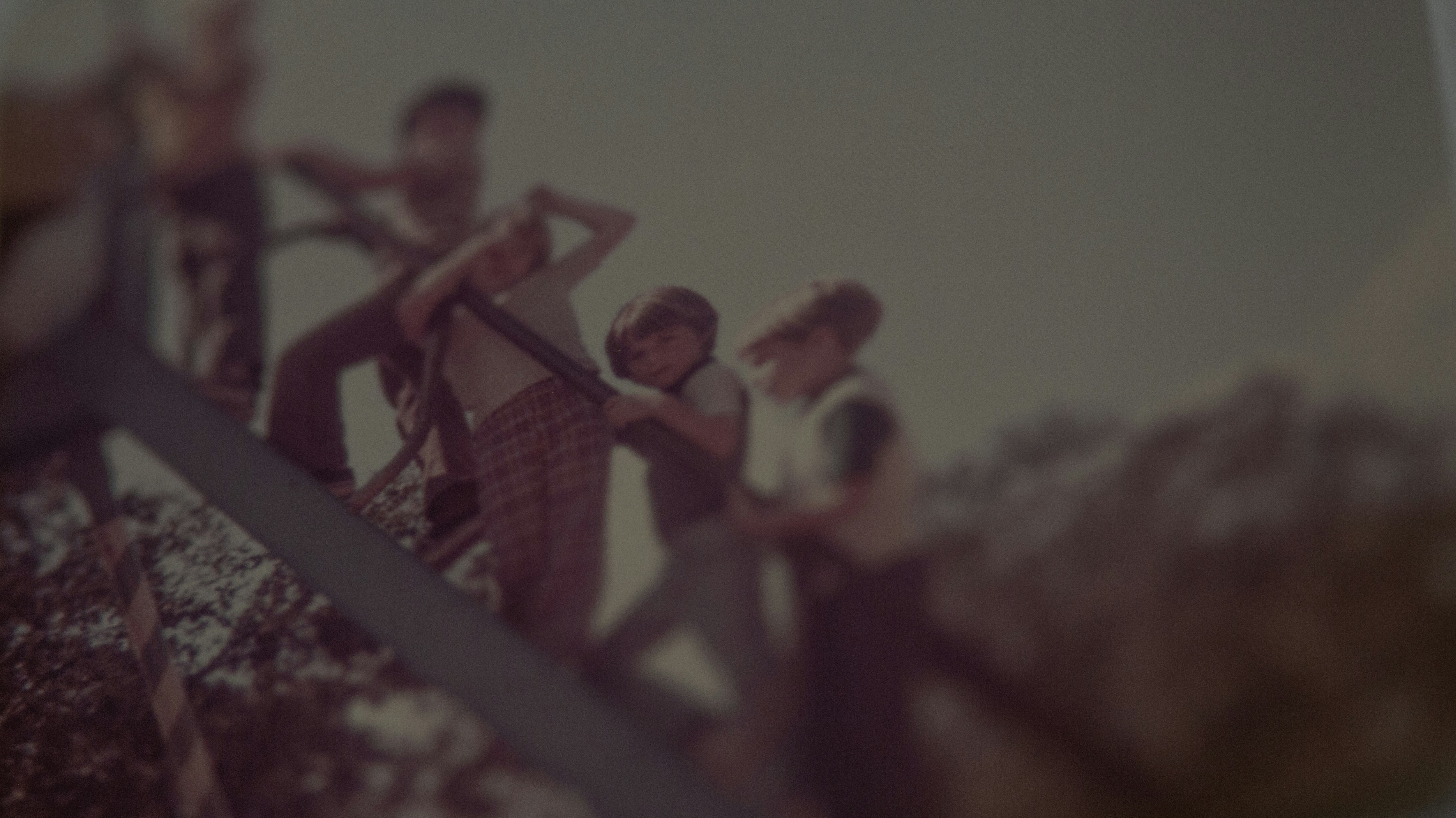 a group of people standing on top of a metal rail
