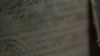 A close-up of official land documents with a magnifying glass