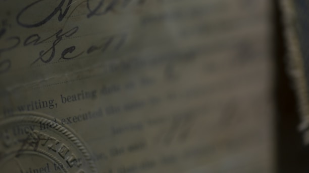Close-up of an antique legal document with elegant handwriting and a vintage seal.